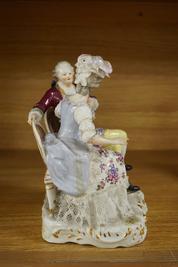 A Sitzendorf tete-a-tete porcelain figure group, signed to the base, 21cm high. Condition - fair, some losses and firing cracks